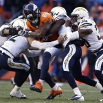 Denver Broncos wide receiver Demaryius Thomas (88) is wrapped up by the San Diego Chargers defense in the third quarter of an NFL AFC division playoff football game, Sunday, Jan. 12, 2014, in Denver. (AP Photo/Charlie Riedel)