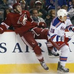 Phoenix Coyotes defenseman Keith Yandle, left, is checked by New York Rangers left-winger Ruslan Fedotenko (26), of Ukraine, in the first period of an NHL hockey game Saturday, Dec. 17, 2011 in Glendale, Ariz. (AP Photo/Paul Connors)