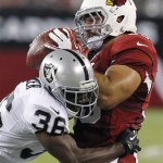 Arizona Cardinals running back Anthony Sherman pulls down a pass against Oakland Raiders defensive back Shawntae Spencer during the first half of a preseason NFL football game, Friday, Aug. 17, 2012, in Glendale, Ariz. (AP Photo/Ross D. Franklin)
