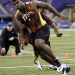Alabama offensive lineman D J Fluker goes through a drill during the NFL Scouting Combine in Indianapolis Saturday, Feb. 23, 2013. (AP Photo/Dave Martin)
