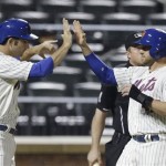 New York Mets' Andrew Brown, right, and Josh Satin celebrate after both scored on a single by Omar Quintanilla during the seventh inning of a baseball game Tuesday, July 2, 2013, in New York. (AP Photo/Frank Franklin II)