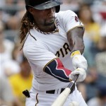 Pittsburgh Pirates' Andrew McCutchen drives in two runs with a single off Philadelphia Phillies starting pitcher Cole Hamels during the third inning of a baseball game in Pittsburgh on Thursday, July 4, 2013. (AP Photo/Gene J. Puskar)