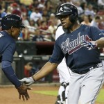 Atlanta Braves' Justin Upton, right, celebrates his two-run home run against the Arizona Diamondbacks, his former team, with teammate and brother B.J. Upton during the sixth inning of a baseball game, on Monday, May 13, 2013, in Phoenix. (AP Photo/Ross D. Franklin)