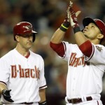 Arizona Diamondbacks' Gerardo Parra, right, celebrates with teammate Willie Bloomquist, left, in the first inning after hitting a solo home run against the Cincinnati Reds during a baseball game on Friday, June. 21, 2013, in Phoenix. (AP Photo/Rick Scuteri)