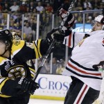 Boston Bruins defenseman Torey Krug (47) shoves Chicago Blackhawks left wing Viktor Stalberg, right, of Sweden,during the first period in Game 3 of the NHL hockey Stanley Cup Finals in Boston, Monday, June 17, 2013. (AP Photo/Elise Amendola)