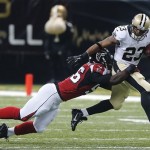 New Orleans Saints running back Pierre Thomas (23) tries to elude a tackle by Atlanta Falcons outside linebacker Sean Weatherspoon (56) in the first half of an NFL football game in New Orleans, Sunday, Sept. 8, 2013. (AP Photo/Bill Haber)