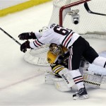 Chicago Blackhawks center Andrew Shaw (65) collides with Boston Bruins goalie Tuukka Rask, underneath, of Finland,during the first period in Game 3 of the NHL hockey Stanley Cup Finals in Boston, Monday, June 17, 2013. (AP Photo/Charles Krupa)