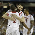 Louisville guard/forward Luke Hancock (11) embraces Louisville guard Russ Smith (2) after defeating Michigan after the second half of the NCAA Final Four tournament college basketball championship game Monday, April 8, 2013, in Atlanta. Louisville won 82-76. (AP Photo/David J. Phillip)