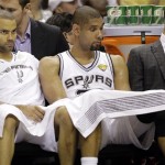 San Antonio Spurs' Tony Parker and Tim Duncan watch during the second half at Game 4 of the NBA Finals basketball series against the Miami Heat, Thursday, June 13, 2013, in San Antonio. (AP Photo/Eric Gay)