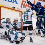 
Vancouver Canucks' Jannik Hansen, right, of Denmark, celebrates teammate Kevin Bieksa's, not shown, goal as San Jose Sharks' goalie Antti Niemi, of Finland, from left, Logan Couture, Marc-Edouard Vlasic and Raffi Torres look on during the second period in game 1 of an NHL Western Conference quarter-final playoff hockey series in Vancouver, British Columbia Wednesday May 1, 2013. (AP Photo/The Canadian Press, Darryl Dyck