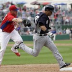 New York Yankees' Walter Ibarra, right, runs past the tag from Philadelphia Phillies' Jeremy Horst for a single during the ninth inning of an exhibition spring training baseball game, Tuesday, Feb. 26, 2013, in Clearwater, Fla. Philadelphia won 4-3. (AP Photo/Matt Slocum)
