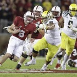  Stanford quarterback Kevin Hogan (8) runs from Oregon defensive tackle Ricky Havili-Heimuli (90) during the second quarter of an NCAA college football game in Stanford, Calif., Thursday, Nov. 7, 2013. (AP Photo/Marcio Jose Sanchez)