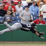 New York Yankees' Walter Ibarra dives after catching a pop foul out by Philadelphia Phillies' Steven Lerud during the sixth inning of an exhibition spring training baseball game, Tuesday, Feb. 26, 2013, in Clearwater, Fla. Philadelphia won 4-3. (AP Photo/Matt Slocum)