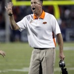 Oklahoma State head coach Mike Gundy signals for fourth down against Arizona at the end of the first quarter of an NCAA college football game at Arizona Stadium in Tucson, Ariz., Sat., Sept. 8, 2012. (AP Photo/Wily Low)
