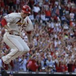 St. Louis Cardinals' David Freese jumps over home plate after scoring from third on a sacrifice fly by Jon Jay during the fifth inning of Game 2 of the National League baseball championship series against the Los Angeles Dodgers Saturday, Oct. 12, 2013, in St. Louis. (AP Photo/Jeff Roberson)