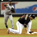 Arizona Diamondbacks' Paul Goldschmidt, right, ducks out of the way as Milwaukee Brewers' Jean Segura throws out Aaron Hill on a ground-out during the fourth inning of a baseball game on Thursday, July 11, 2013, in Phoenix. (AP Photo/Matt York)