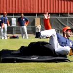 Houston Astros outfielder J.D. Martinez (14) laughs as he finishes his landing during a sliding drill with first base coach Dave Clark (35) during spring training workouts at the Osceola County Stadium, Tuesday, Feb. 19, 2013, in Kissimmee, Fla. (AP Photo/Houston Chronicle, Karen Warren) 