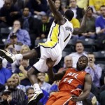 Indiana Pacers guard Lance Stephenson (1) draws the charge from Atlanta Hawks forward Ivan Johnson as he makes a shot in the first half of Game 2 of a first-round NBA basketball playoff series in Indianapolis, Wednesday, April 24, 2013. (AP Photo/Michael Conroy)