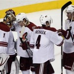 From left to right, Phoenix Coyotes goalie Thomas Greiss, Tim Kennedy, Zbynek Michalek and Michael Stone celebrate after defeating the Philadelphia Flyers 2-1 in an NHL hockey game, Friday, Oct. 11, 2013, in Philadelphia. (AP Photo/Tom Mihalek)