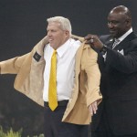 Bill Parcells, left, receives his symbolic gold jacket from his presenter George Martin, right, during the Enshrinees' Gold Jacket Dinner at the Canton Memorial Civic Center Friday, Aug. 2, 2013 in Canton, OH. Parcells will be enshrined into the Pro Football Hall of Fame Saturday. (AP Photo/The Repository, Scott Heckel)
