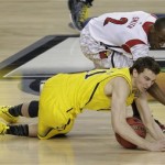 Louisville guard Russ Smith (2) and Michigan guard Nik Stauskas (11) vie for a loose ball during the second half of the NCAA Final Four tournament college basketball championship game Monday, April 8, 2013, in Atlanta. (AP Photo/Chris O'Meara)