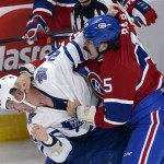 Montreal Canadiens right wing George Parros, right, fights with Toronto Maple Leafs right wing Colton Orr during second period of an NHL hockey game on Tuesday, Oct. 1, 2013, in Montreal. (AP Photo/The Canadian Press, Ryan Remiorz)
