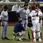 American League's Robinson Cano, of the New York Yankees, is attended to after being hit by a pitch from National League's Matt Harvey, of the New York Mets, during the first inning of the MLB All-Star baseball game, on Tuesday, July 16, 2013, in New York. (AP Photo/Frank Franklin II)