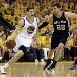 Golden State Warriors guard Klay Thompson (11) drives past San Antonio Spurs center Tiago Splitter (22) during the first quarter of Game 6 of a Western Conference semifinal NBA basketball playoff series in Oakland, Calif., Thursday, May 16, 2013. (AP Photo/Marcio Jose Sanchez)