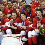 Members of Team Canada pose for a photo with their gold medals after the gold medal men's ice hockey game at the 2014 Winter Olympics, Sunday, Feb. 23, 2014, in Sochi, Russia. Canada defeated Sweden 3-0 in the game. (AP Photo/Mark Humphrey)