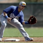 Los Angeles Dodgers infielder Skip Schumaker fields a ball during spring training baseball in Phoenix, Thursday, Feb. 21, 2013. (AP Photo/Paul Sancya)