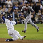Los Angeles Dodgers' Juan Uribe slides into second with a double off Atlanta Braves starting pitcher Freddy Garcia, rear, in the sixth inning of Game 4 in the National League division baseball series Monday, Oct. 7, 2013, in Los Angeles. (AP Photo/Jae C. Hong)