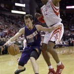  Phoenix Suns' Goran Dragic (1) tries to drive past Houston Rockets' Dwight Howard (12) during the second quarter of an NBA basketball game Wednesday, Dec. 4, 2013, in Houston. (AP Photo/David J. Phillip)