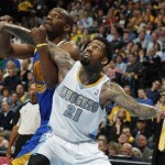 Golden State Warriors forward Carl Landry, left, battles for position for a rebound with Denver Nuggets forward Wilson Chandler during the first quarter of Game 5 of their first-round NBA basketball playoff series, Tuesday, April 30, 2013, in Denver. (AP Photo/David Zalubowski)