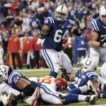 Indianapolis Colts' Donald Brown (31) fumbles before the Colts' Andrew Luck (12) recovered the football and went in for a five-yard touchdown during the second half of an NFL wild-card playoff football game Saturday, Jan. 4, 2014, in Indianapolis. (AP Photo/AJ Mast)