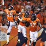 Denver Broncos' Dominique Rodgers-Cromartie (45), Rahim Moore (26) and Malik Jackson (97) celebrate a stop against the Baltimore Ravens during the second half of an NFL football game, Thursday, Sept. 5, 2013, in Denver. (AP Photo/Jack Dempsey)