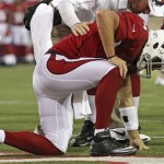 Arizona Cardinals quarterback Kevin Kolb (4) is helped by a team 
trainer after being hit by New Orleans Saints defensive tackle Sedrick 
Ellis (98) during the first quarter of the NFL Hall of Fame exhibition 
football game, Sunday, Aug. 5, 2012 in Canton, Ohio. (AP Photo/Scott 
Galvin)
