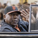 Former San Francisco Giants player Willie McCovey waves to the crowd while riding in a car during a baseball World Series parade in downtown San Francisco, Wednesday, Nov. 3, 2010. The Giants defeated the Texas Rangers in five games for their first championship since the team moved west from New York 52 years ago. (AP Photo/Jeff Chiu)