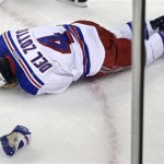 New York Rangers defenseman Michael Del Zotto (4) grabs his head after being hit by the puck during the first period in Game 1 of an NHL hockey playoffs Eastern Conference semifinal game against the Boston Bruins in Boston, Thursday, May 16, 2013. (AP Photo/Charles Krupa)