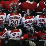 Canada baseball fans wear hockey helmets as they watch Canada play the United States in the fourth inning during a World Baseball Classic baseball game on Sunday, March 10, 2013, in Phoenix. (AP Photo/Ross D. Franklin)
