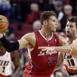 Los Angeles Clippers forward Blake Griffin, left, looks to pass as Portland Trail Blazers forward Joel Freeland defends during the second half of an NBA preseason basketball game in Portland, Ore., Monday, Oct. 7, 2013. The Clippers won 89-81. (AP Photo/Don Ryan)