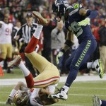  San Francisco 49ers' Colin Kaepernick is tripped up after a long run during the first half of the NFL football NFC Championship game against the Seattle Seahawks, Sunday, Jan. 19, 2014, in Seattle. (AP Photo/Matt Slocum)
