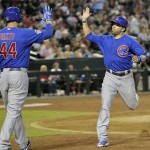 Chicago Cubs' David DeJesus, right, high-fives teammate Anthony Rizzo (44) after scoring on a double by Junior Lake during the fifth inning of a baseball game against the Arizona Diamondbacks, Wednesday, July 24, 2013, in Phoenix. (AP Photo/Matt York)