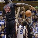 Duke's Rodney Hood (5) tries to shoot as Florida State's Michael Ojo (50) and Robert Gilchrist (14) defend during the first half of an NCAA college basketball game in Durham, N.C., Saturday, Jan. 25, 2014. (AP Photo/Gerry Broome)