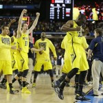 Michigan players react after the second half of the NCAA Final Four tournament college basketball semifinal game against Syracuse, Saturday, April 6, 2013, in Atlanta. Michigan won 61-56. (AP Photo/Charlie Neibergall)
