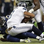 St. Louis Rams defensive end William Hayes (95) sacks Seattle Seahawks quarterback Russell Wilson (3) during the first half of an NFL football game, Monday, Oct. 28, 2013, in St. Louis. (AP Photo/Michael Conroy)
