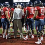 Arizona's defensive line coach Bill Kirelawich, center, talks to his players on the sideline before the start an NCAA college football game against Oklahoma State at Arizona Stadium in Tucson, Ariz., Saturday, Sept. 8, 2012. (AP Photo/John Miller)
