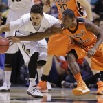 Colorado's Askia Booker, left, keeps the ball away from Oregon State's Ahmad Starks during the first half of a Pac-12 Conference tournament NCAA college basketball game, Wednesday, March 13, 2013, in Las Vegas. (AP Photo/Julie Jacobson)