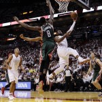 Miami Heat's Dwyane Wade (3) goes to the basket as Milwaukee Bucks' Larry Sanders (8) defends during the first half of Game 1 of their first-round NBA basketball playoff series in Miami, Sunday April 21, 2013. (AP Photo/Alan Diaz)