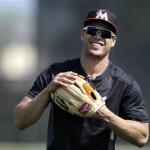 Miami Marlins outfielder Giancarlo Stanton smiles while playing catch before the official start of spring training baseball, Monday, Feb. 11, 2013, in Jupiter, Fla. (AP Photo/Julio Cortez)