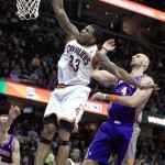 Cleveland Cavaliers' Alonzo Gee (33) dunks against Phoenix Suns' Marcin Gortat, right, during the second quarter of an NBA basketball game Tuesday, Nov. 27, 2012, in Cleveland. (AP Photo/Tony Dejak)